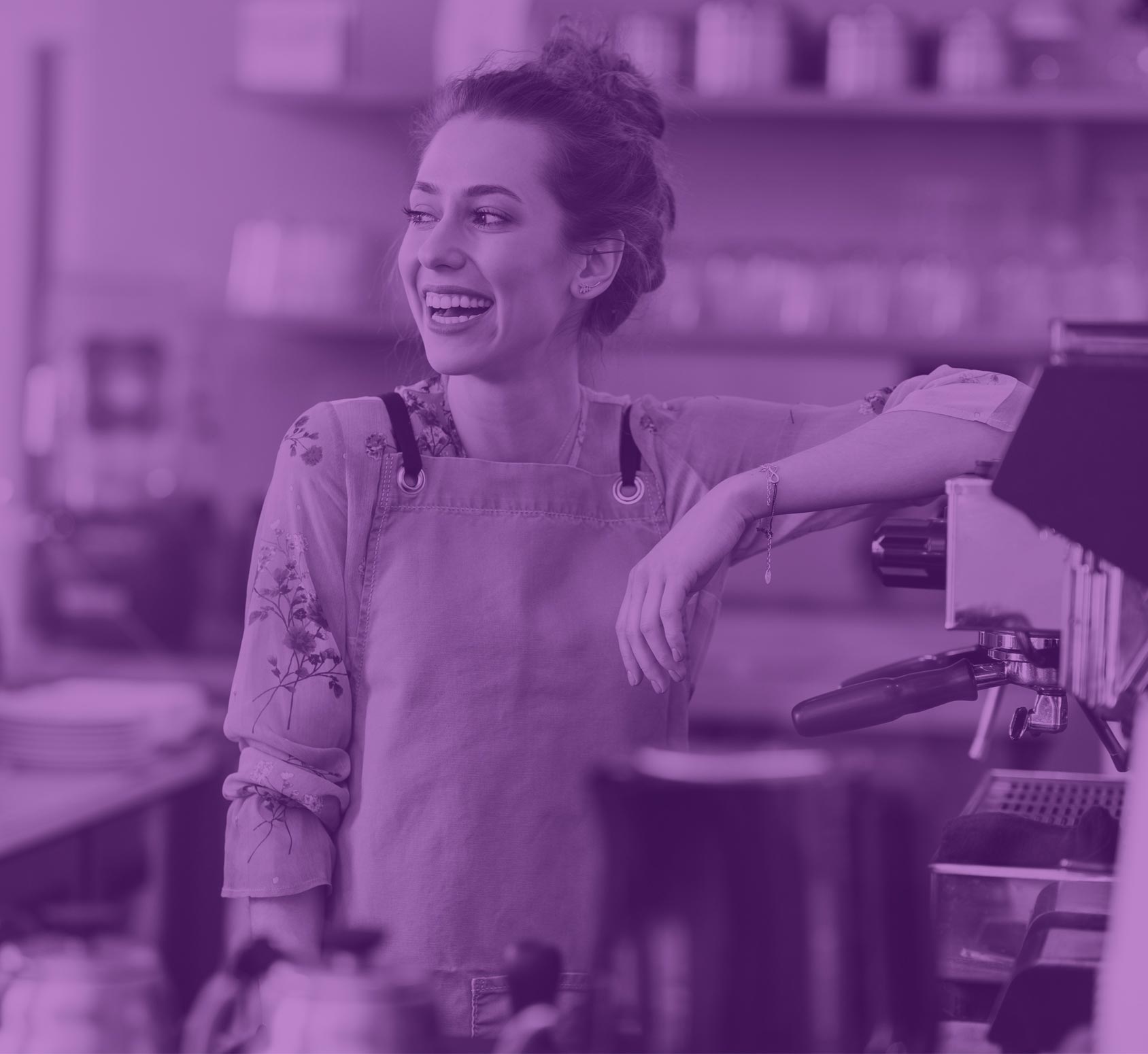 Woman leaning on a counter in a coffee shop