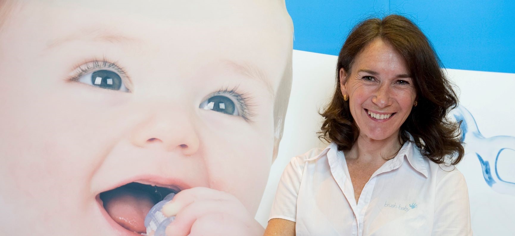 Brush Baby founder Dominique Tillen stood in front of one of her banners