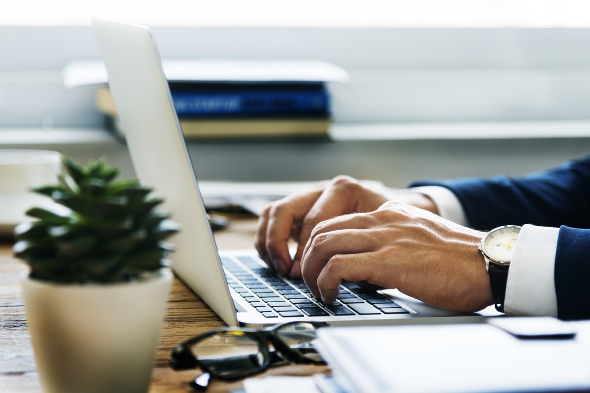 Business man typing on laptop