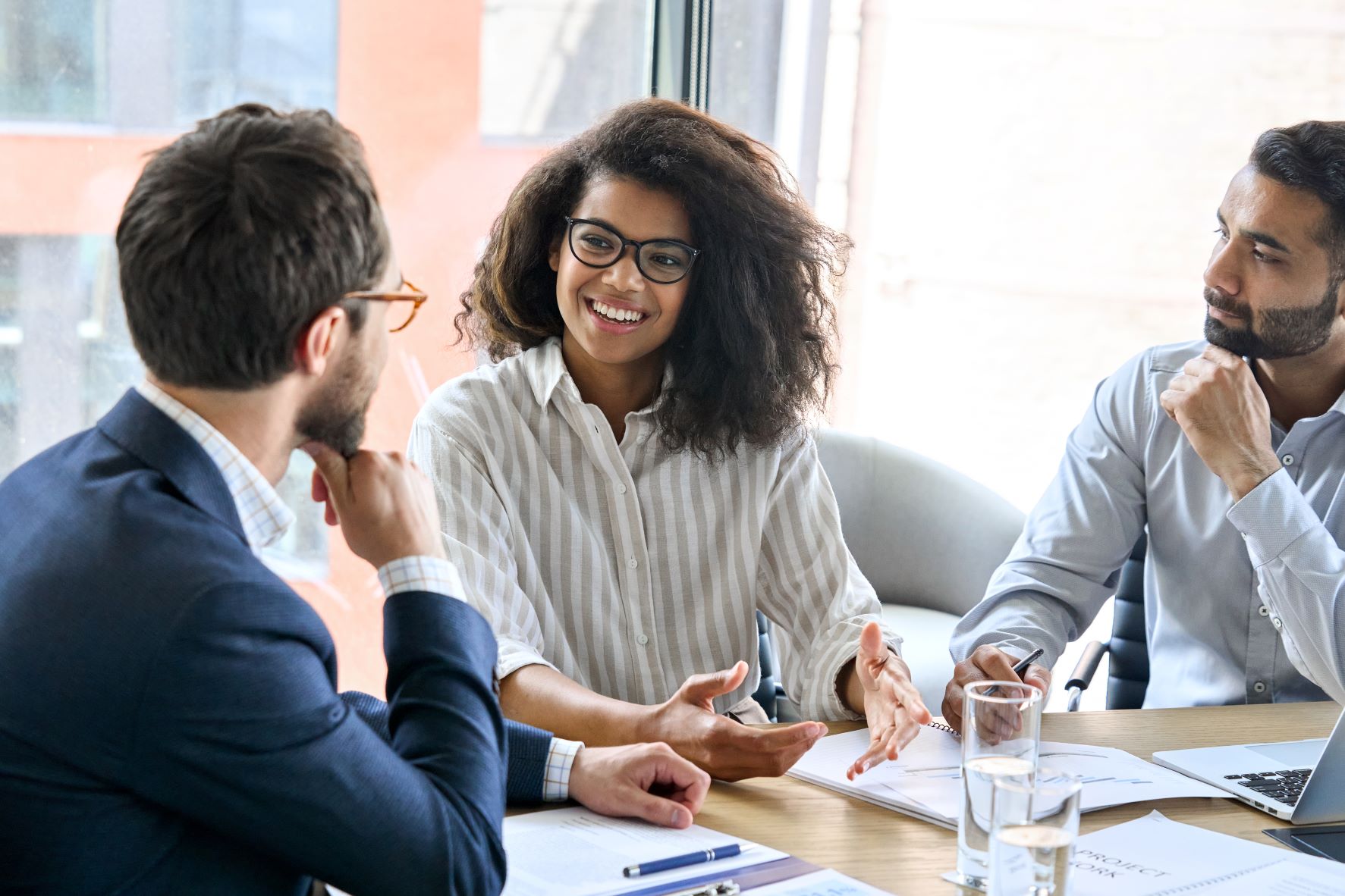 colleagues around a table smiling