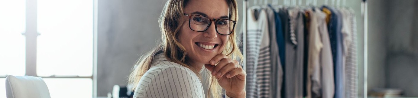 A woman sat at a desk writing on a notepad