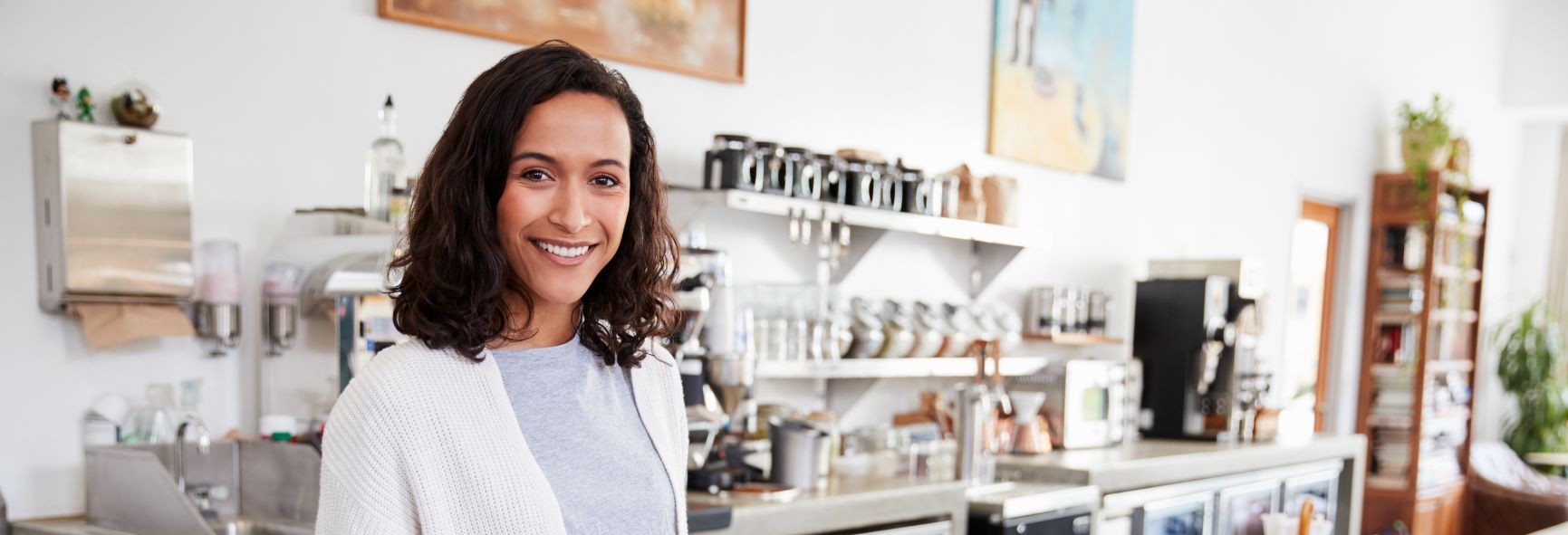 A woman waiting to serve a customer at a coffee shop