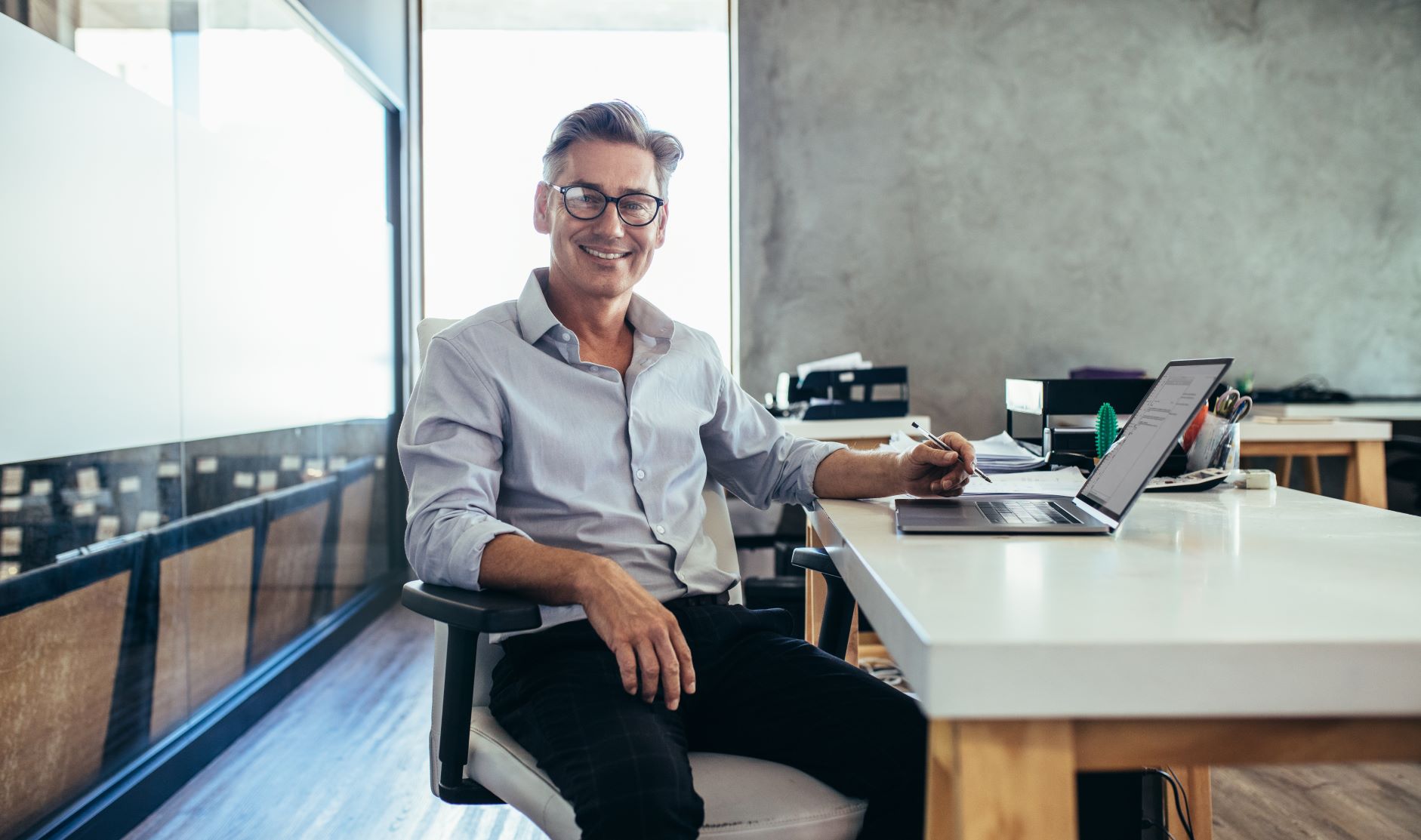 Male businessman smiling at desk