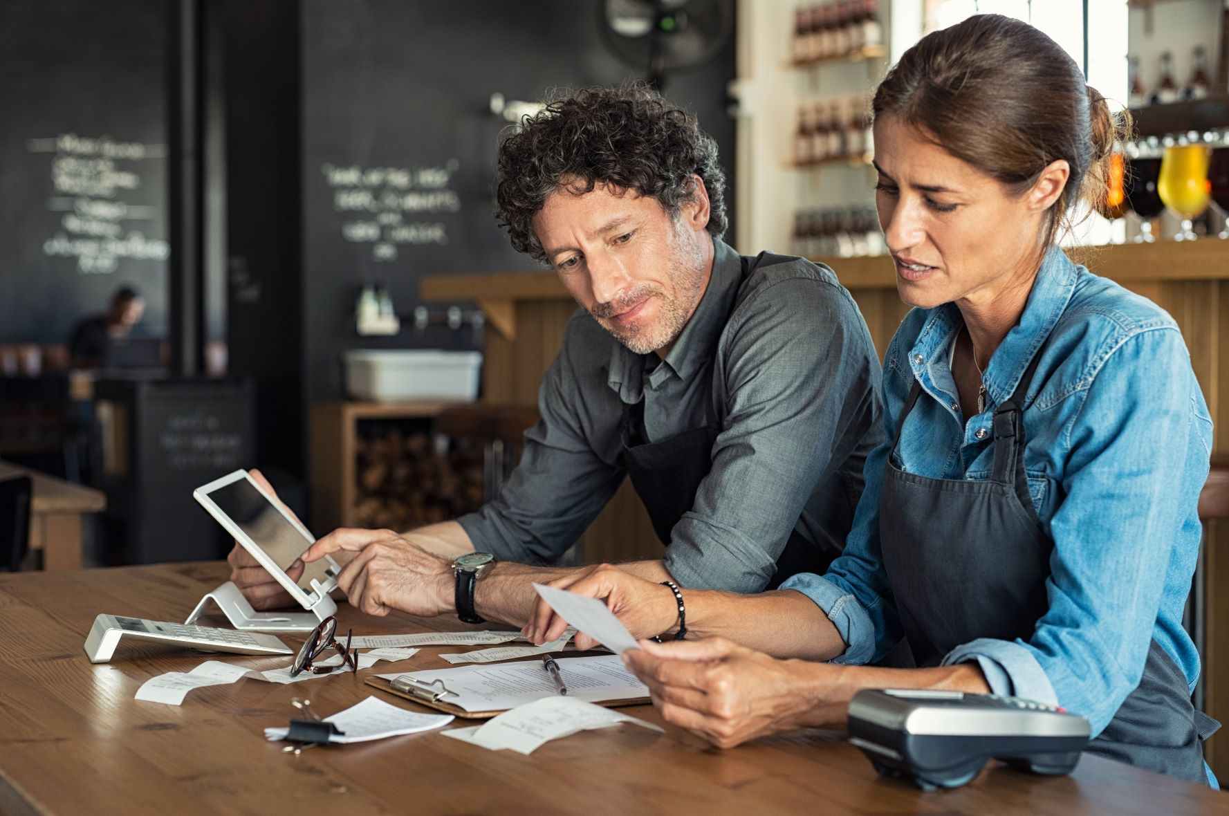 male and female workers looking at invoices