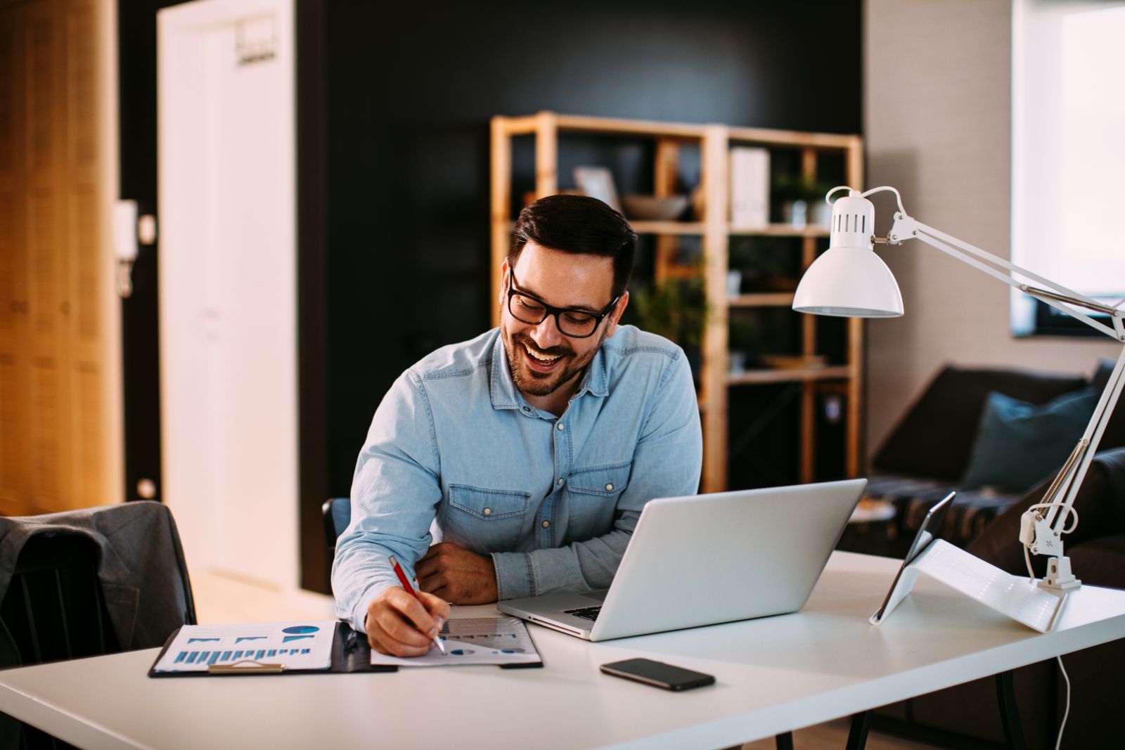 Man working at a desk in  front of laptop