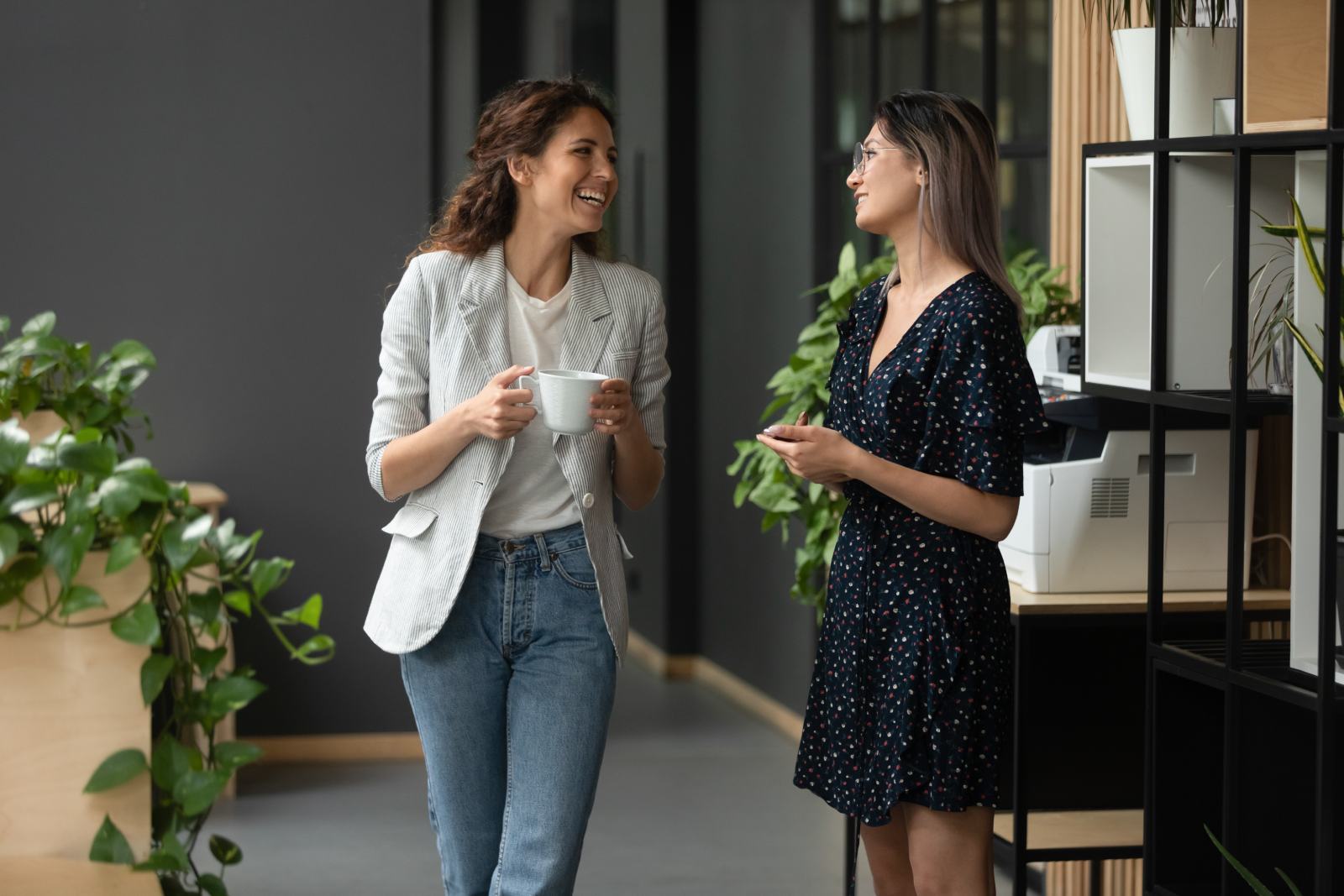 Two women in the office hallway chatting