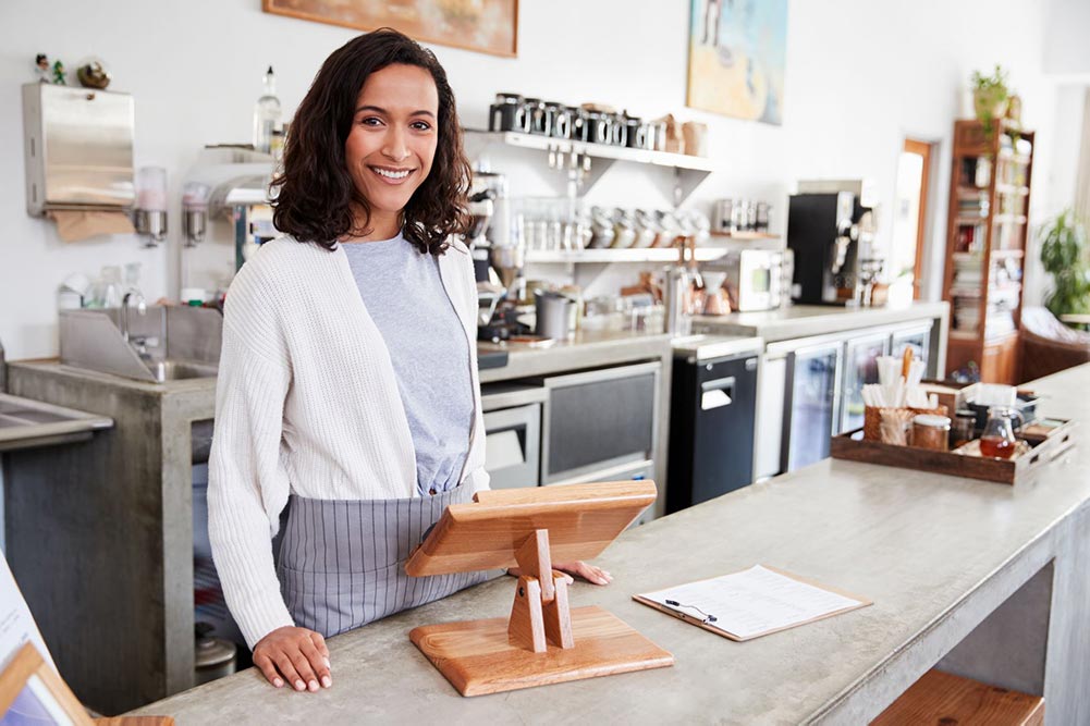 A woman waiting to serve a customer at a coffee shop