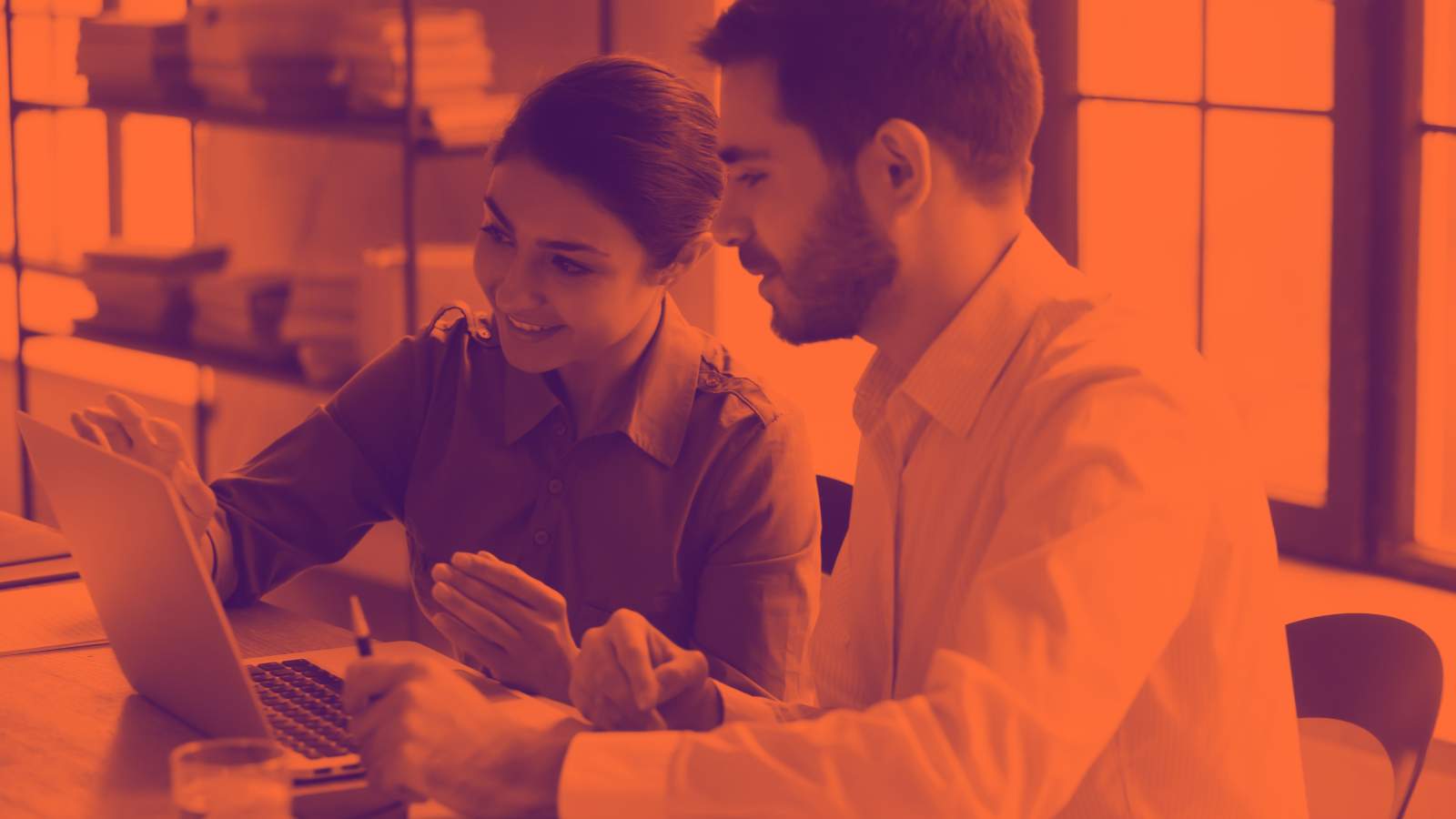 Man and woman working in front of a laptop