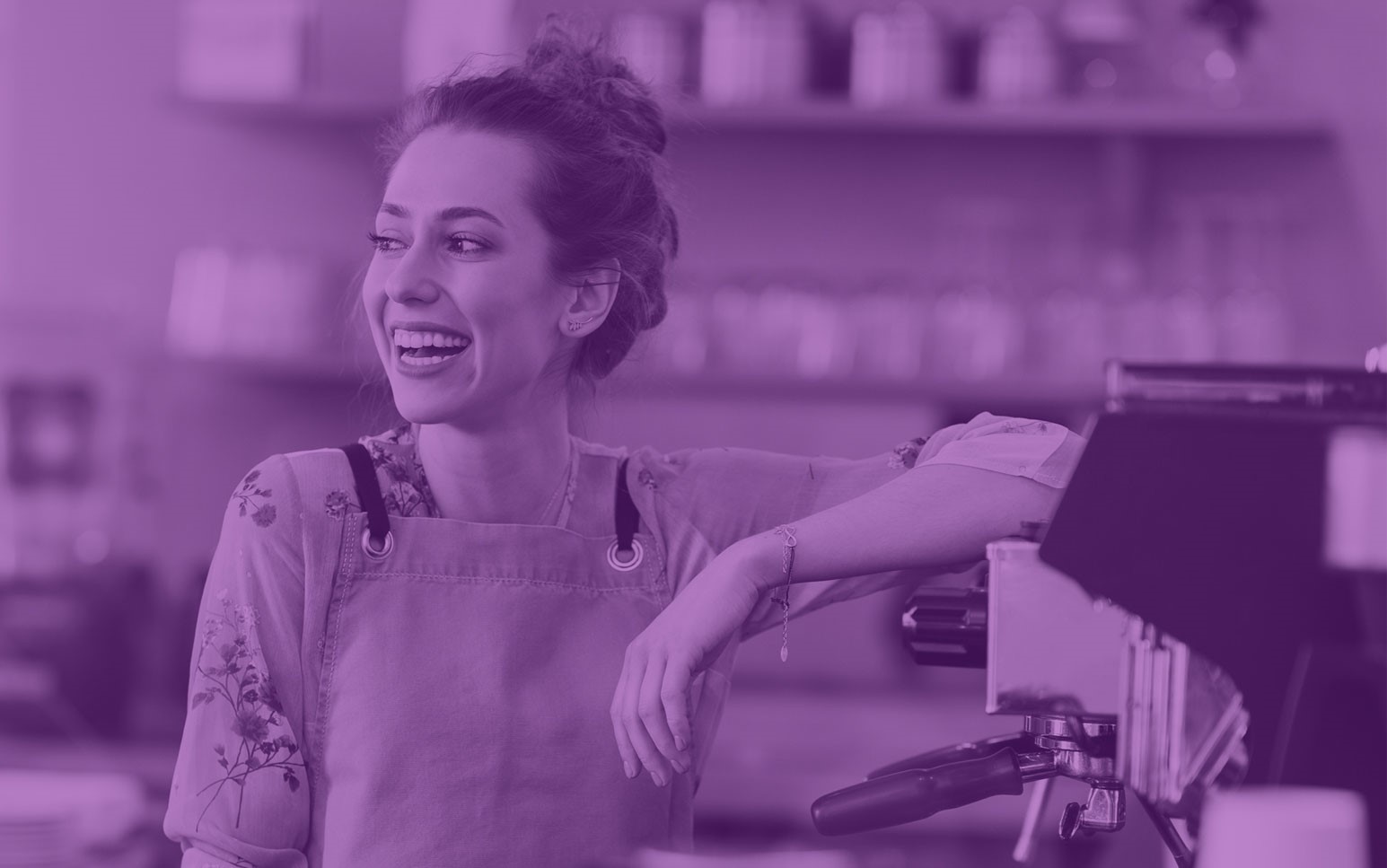 Woman leaning on a counter in a cafe